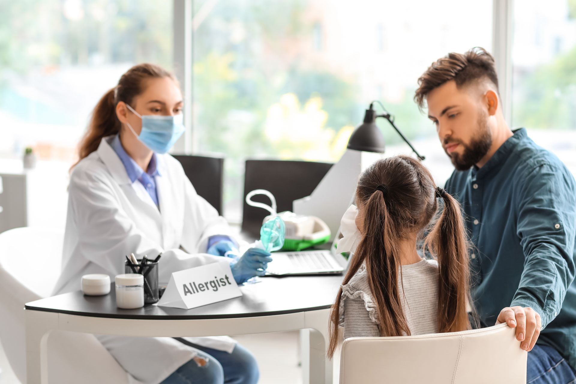 Little girl and her father visiting allergist in clinic. Little girl and her father visiting allergist in clinic.