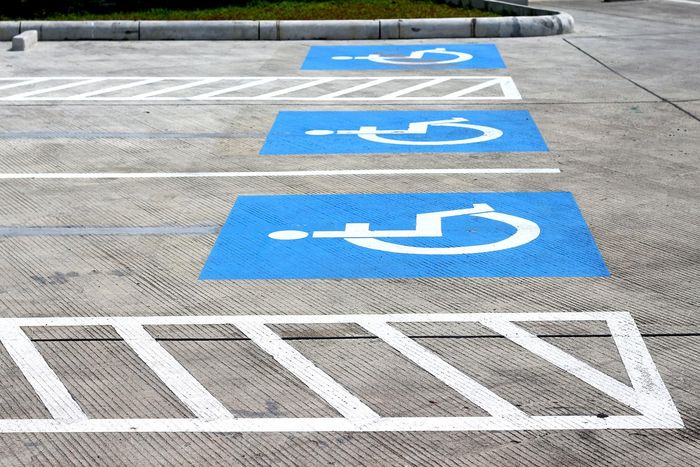 A parking lot with handicapped parking spaces painted blue and white