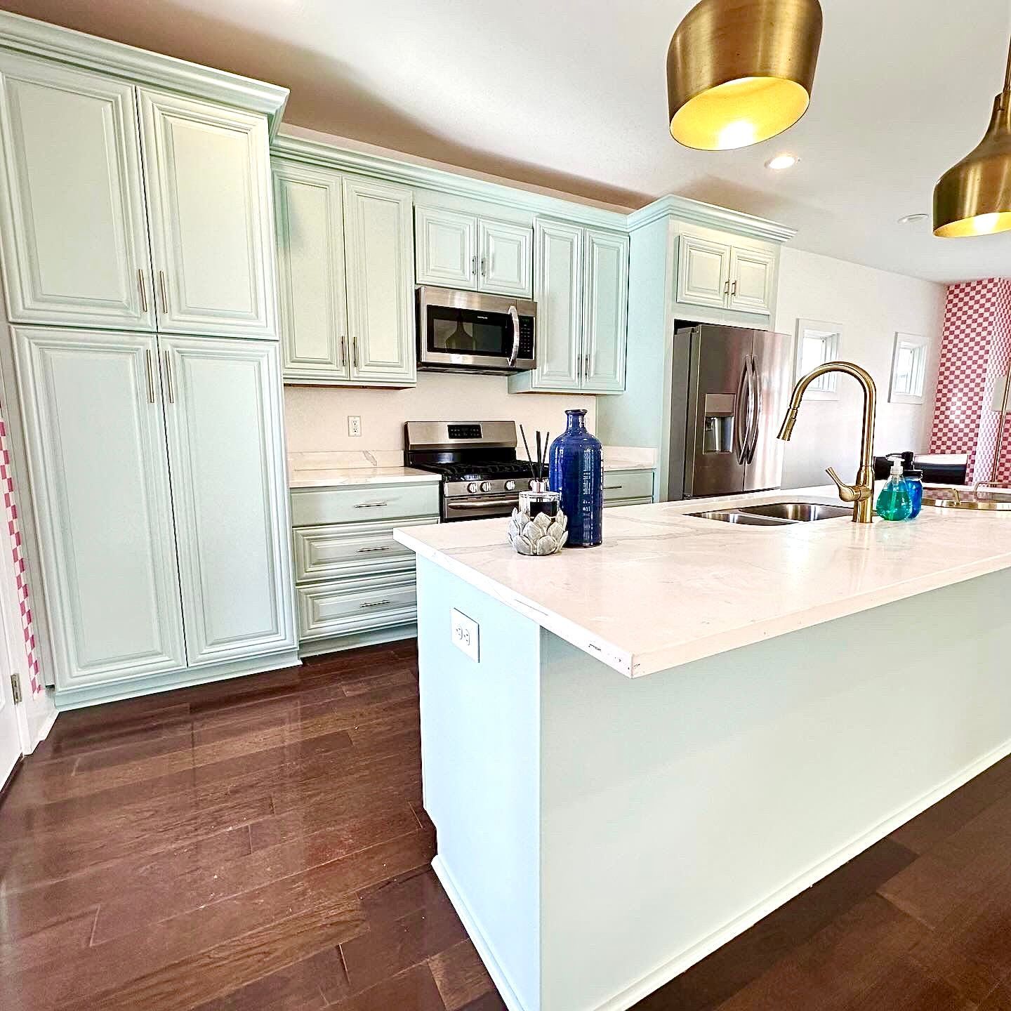 A bathroom with two sinks , a toilet , and a window.