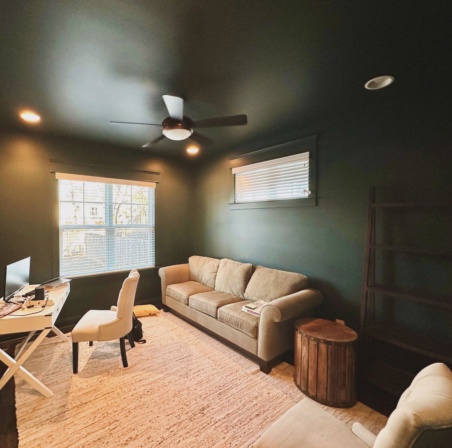 A living room with a couch a desk and a ceiling fan in Nashville, TN