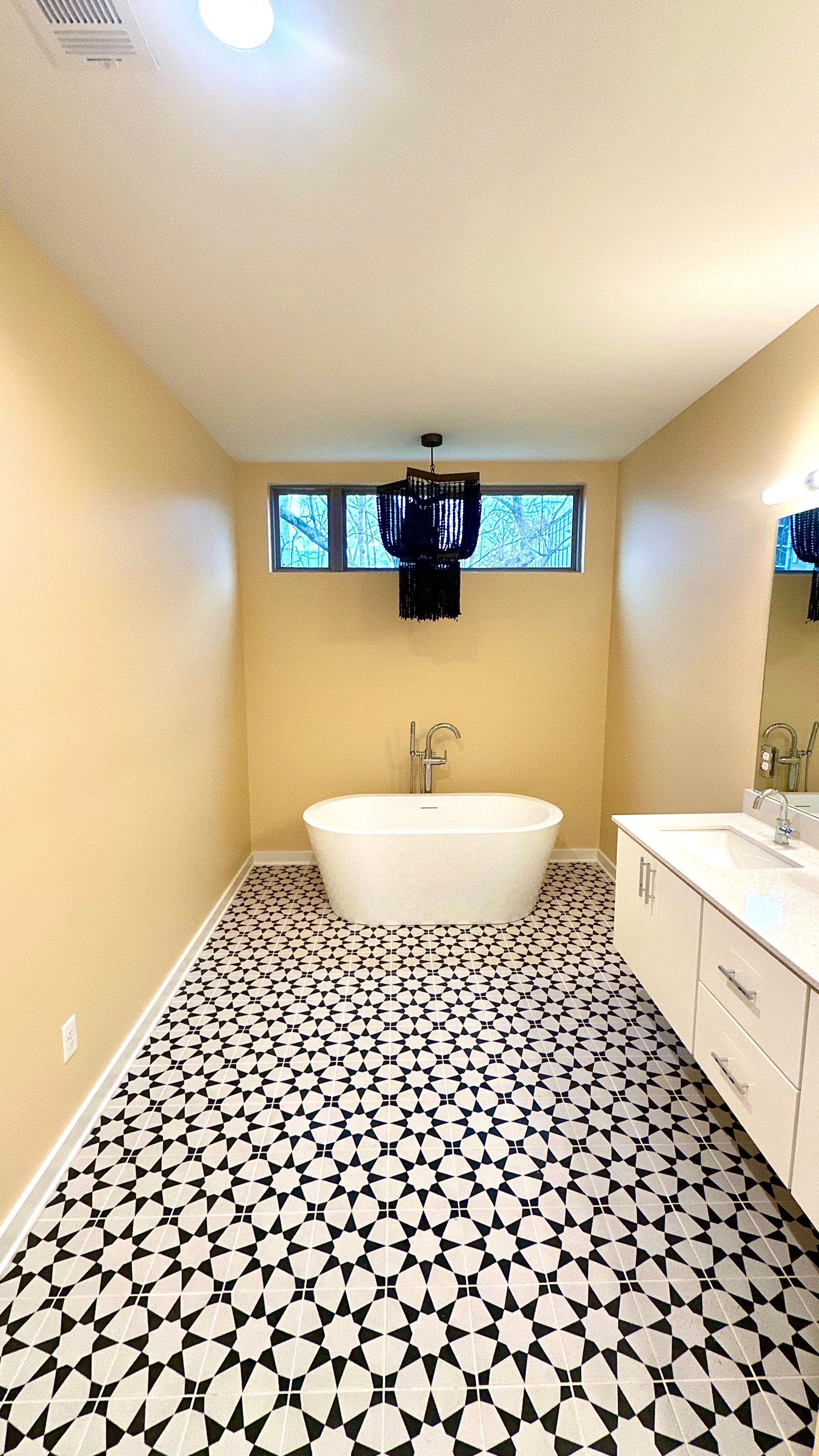 A bathroom with a bathtub , sink and mirror in Nashville, TN