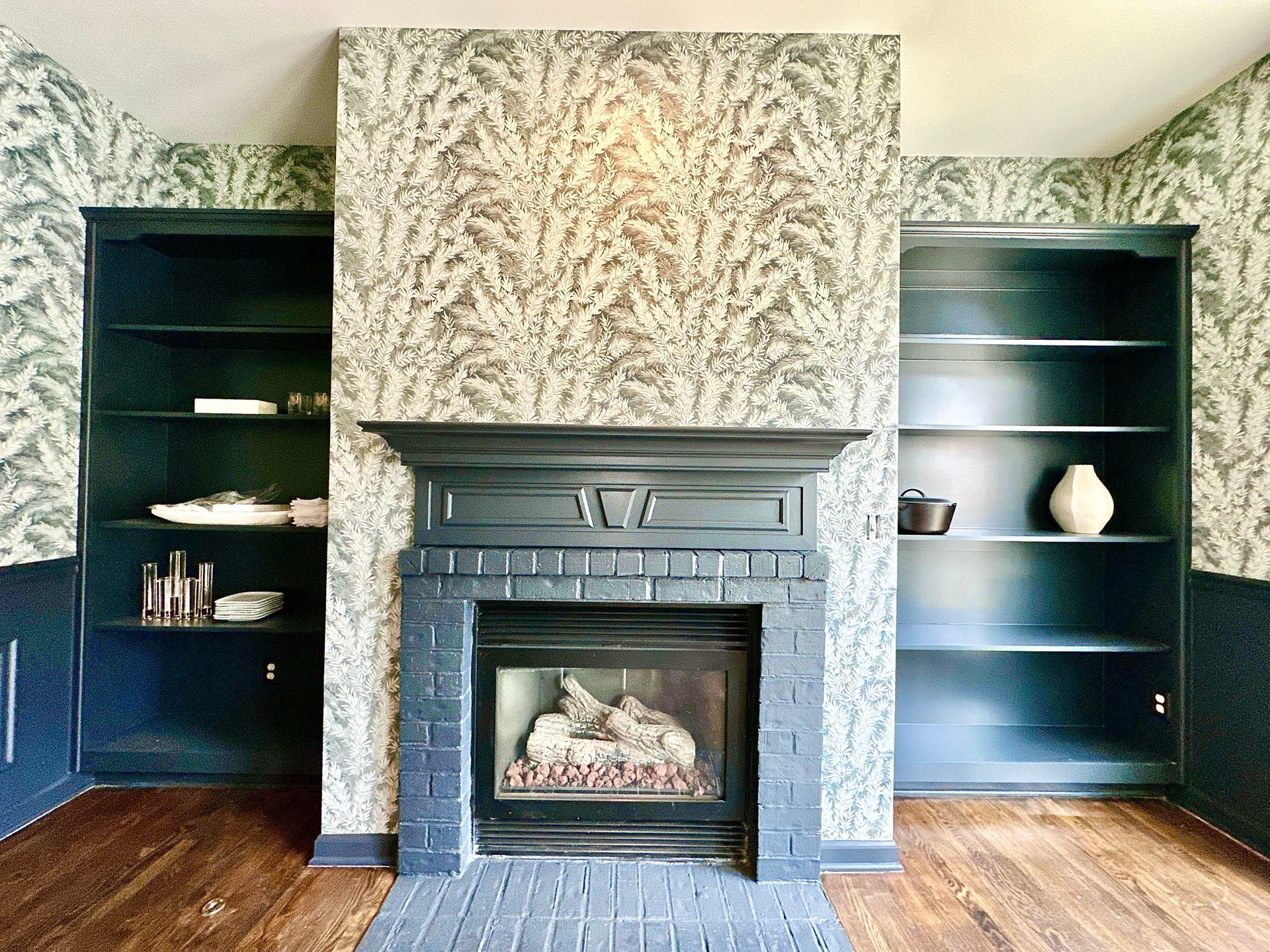 A living room with a fireplace and shelves in Nashville, TN