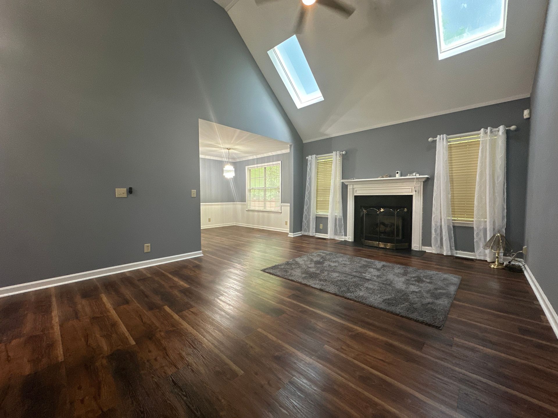 An empty living room with hardwood floors and a fireplace in Nashville, TN