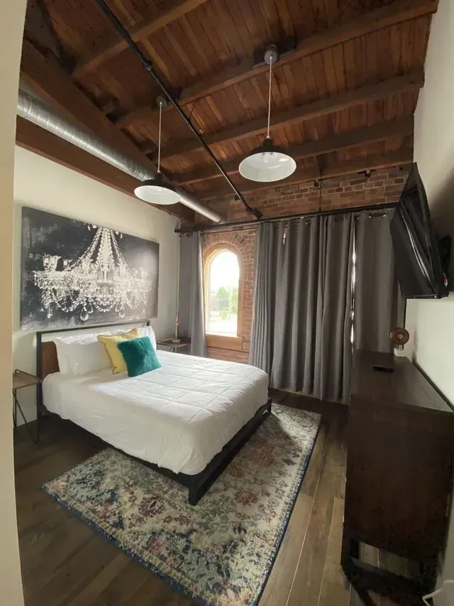 home improvement nashville tn A bedroom with a king size bed , a rug , a dresser and a television.