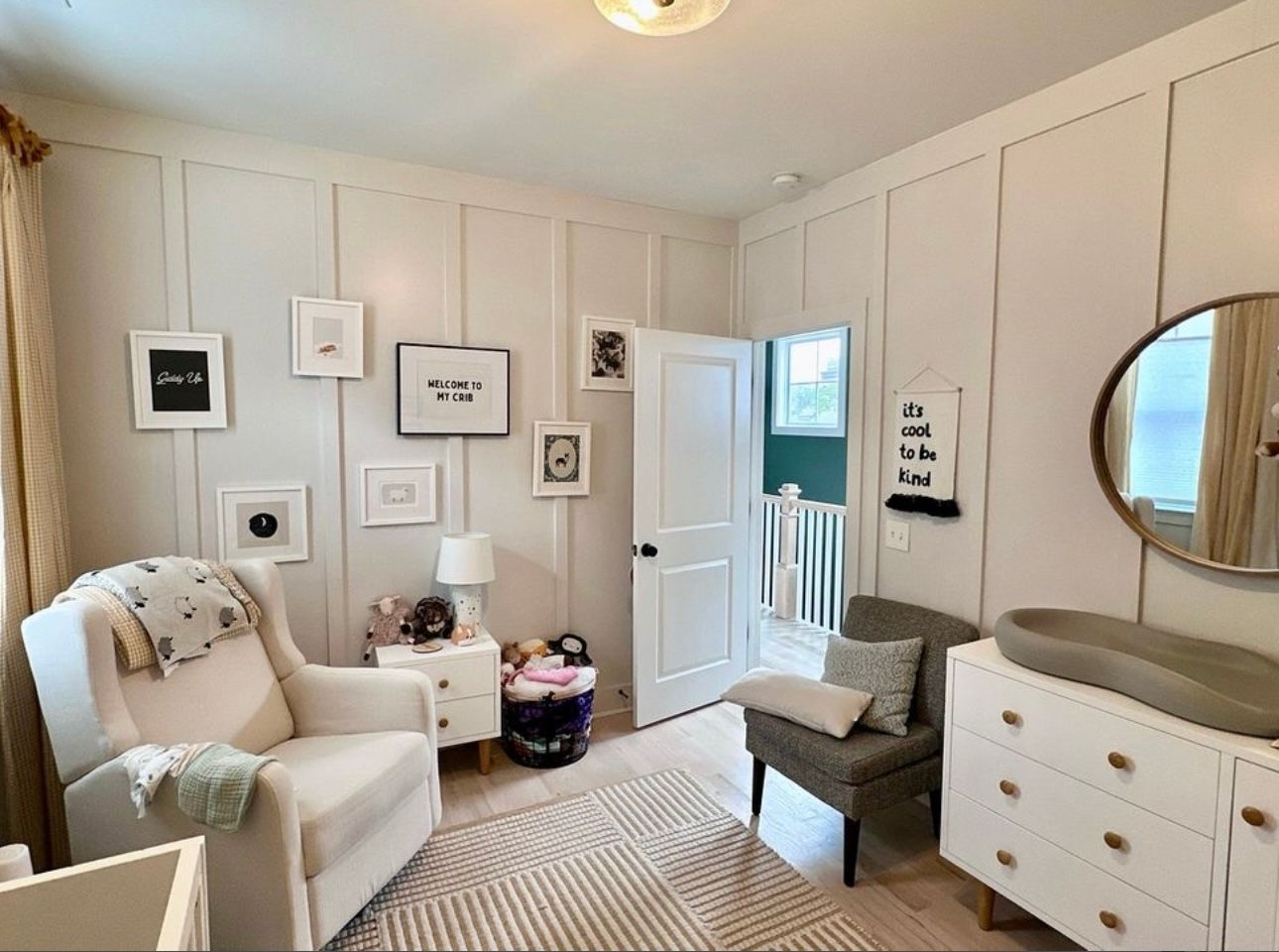 A kitchen with a floral wallpaper on the wall and a sink.