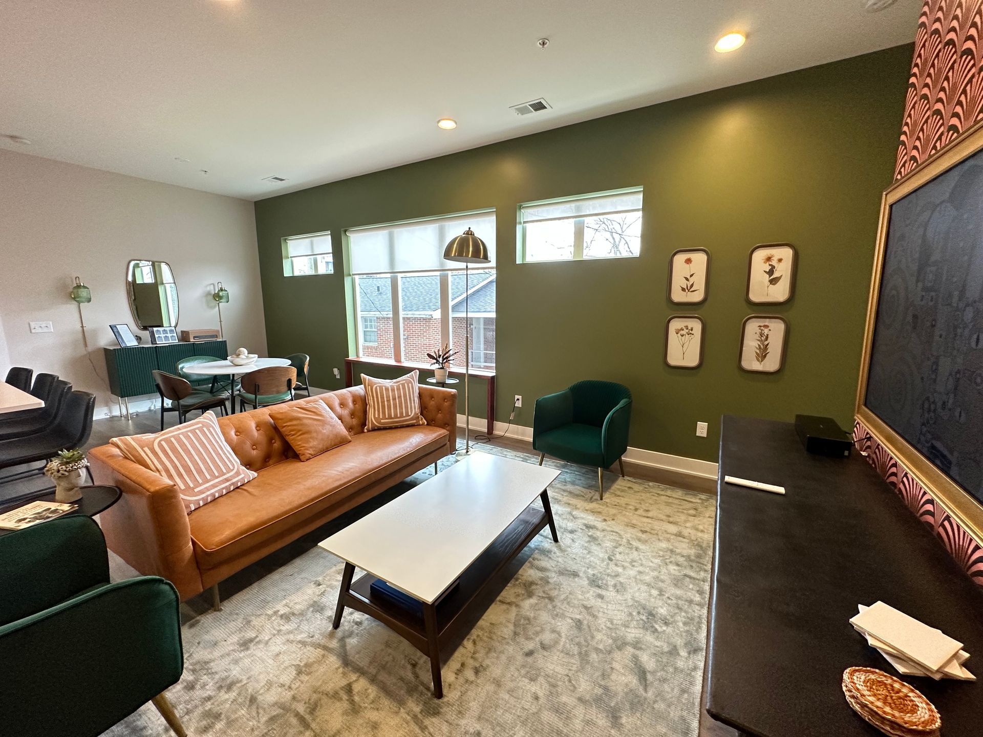 A living room with a couch , chairs , coffee table and television in Nashville, TN
