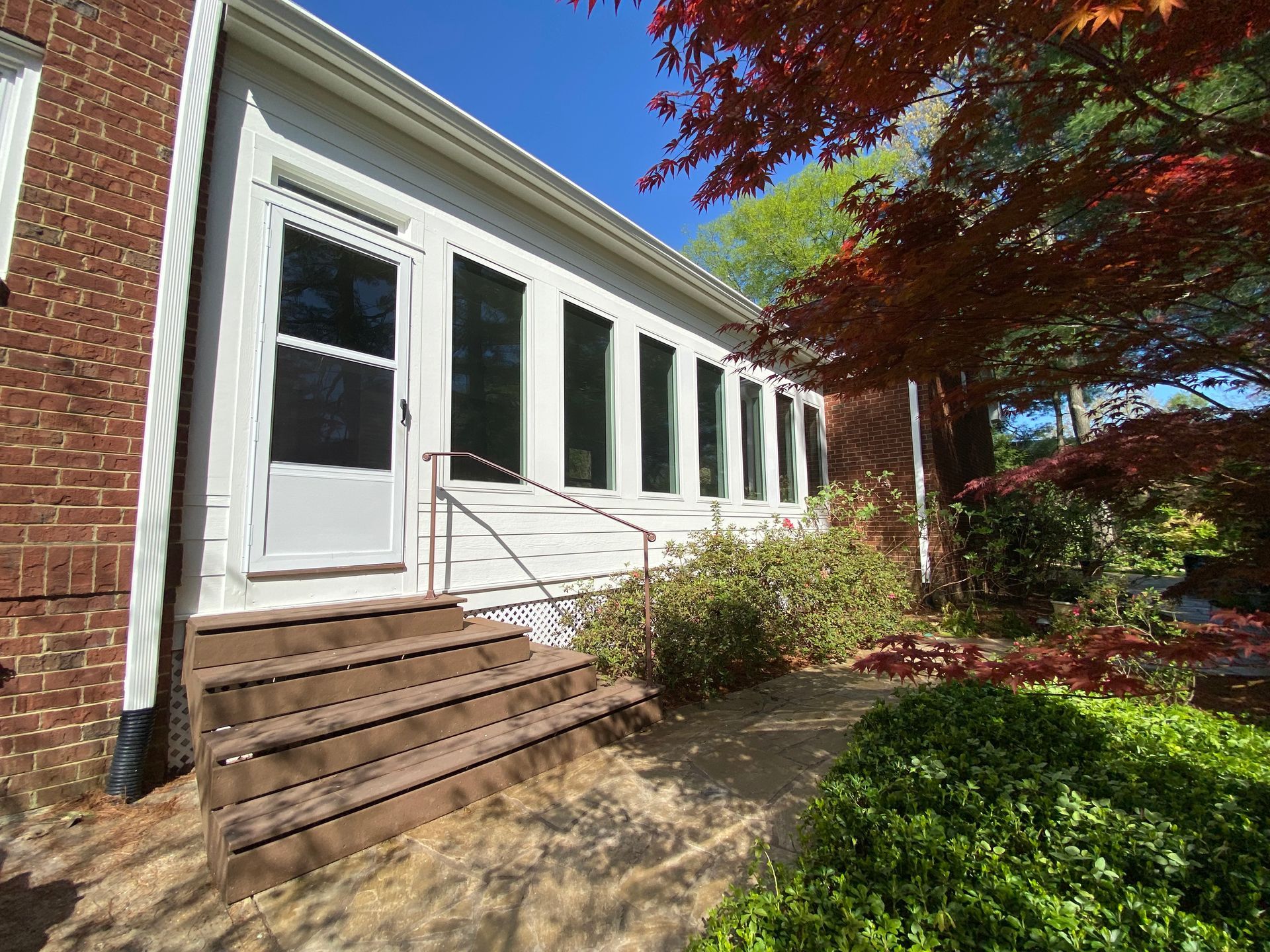A brick house with a white door and stairs in Nashville, TN