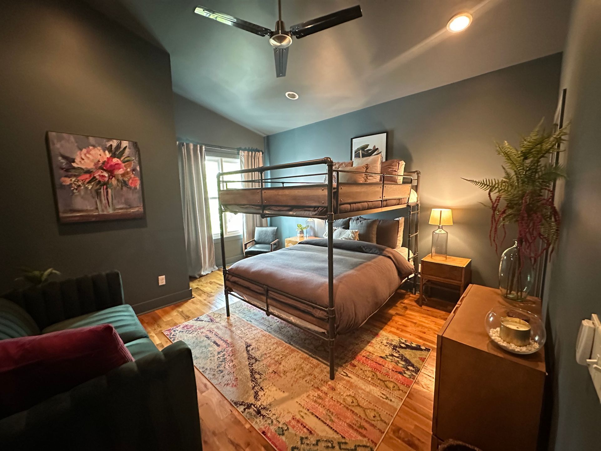 A bedroom with a bunk bed and a couch.