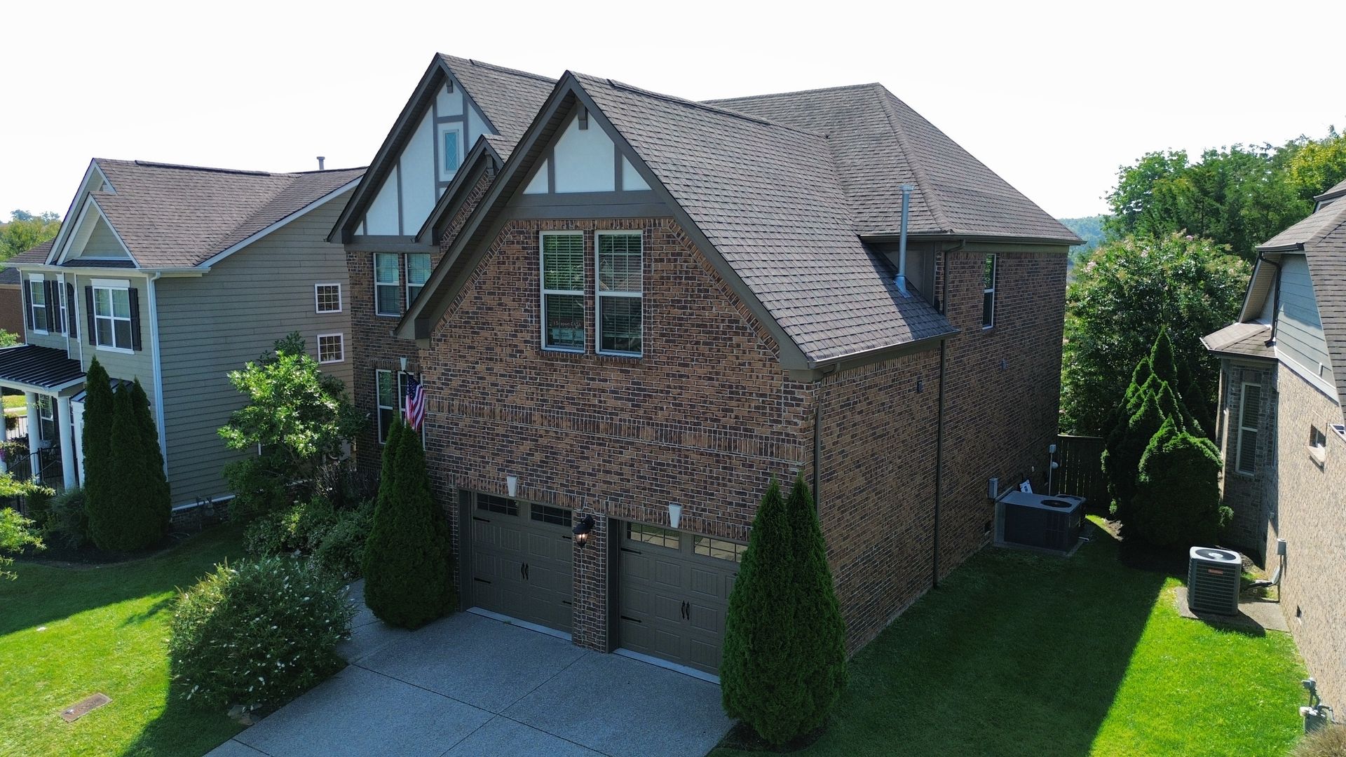 An aerial view of a large brick house with two garages in Nashville, TN