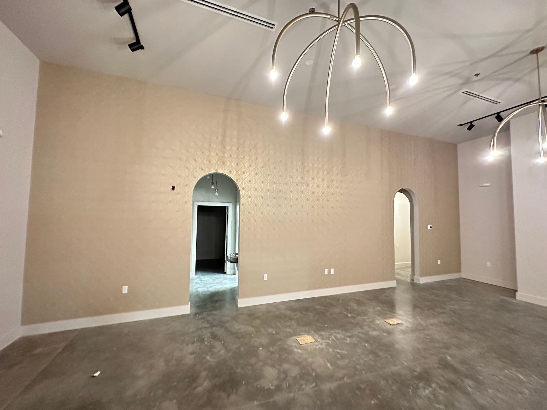 A large empty room with a chandelier hanging from the ceiling in Nashville, TN