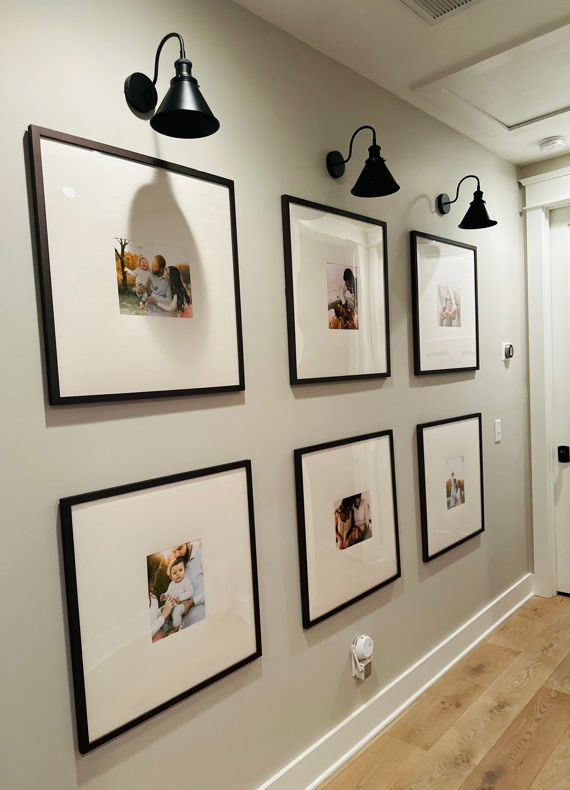 A hallway with a bunch of framed pictures on the wall in Nashville, TN