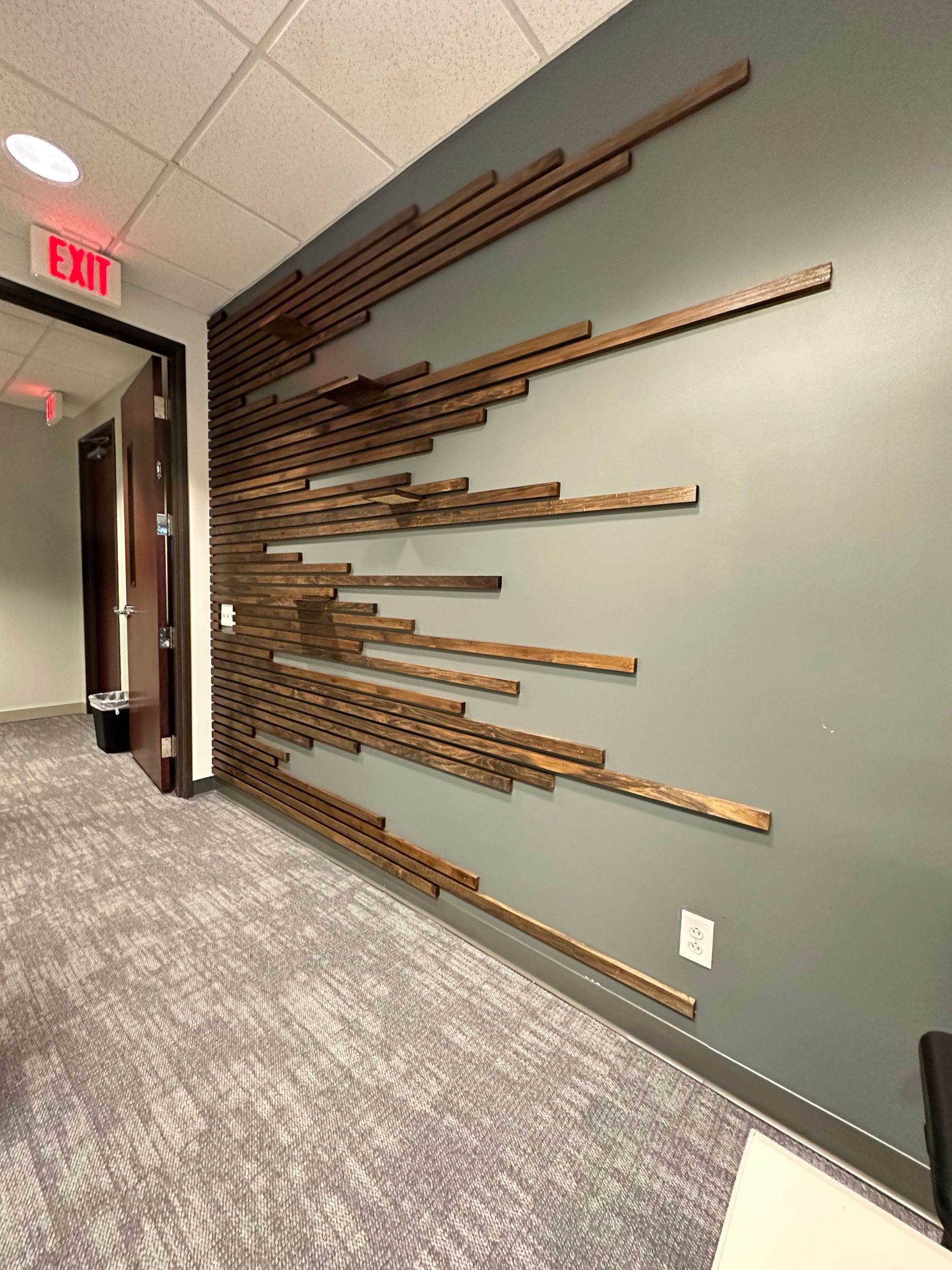 A hallway with a red exit sign on the wall in Nashville, TN