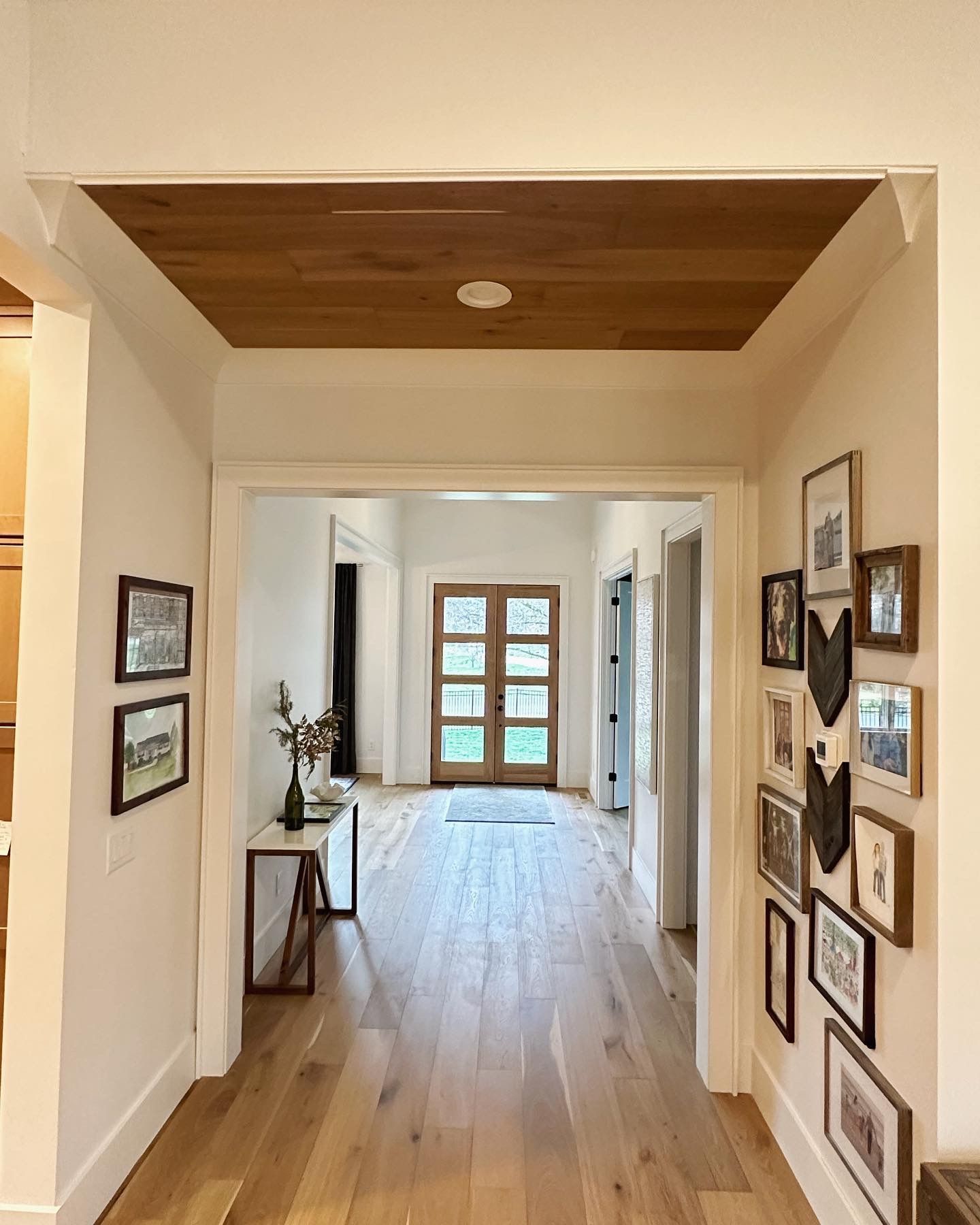 A hallway with pictures on the wall and a wooden ceiling in Nashville, TN