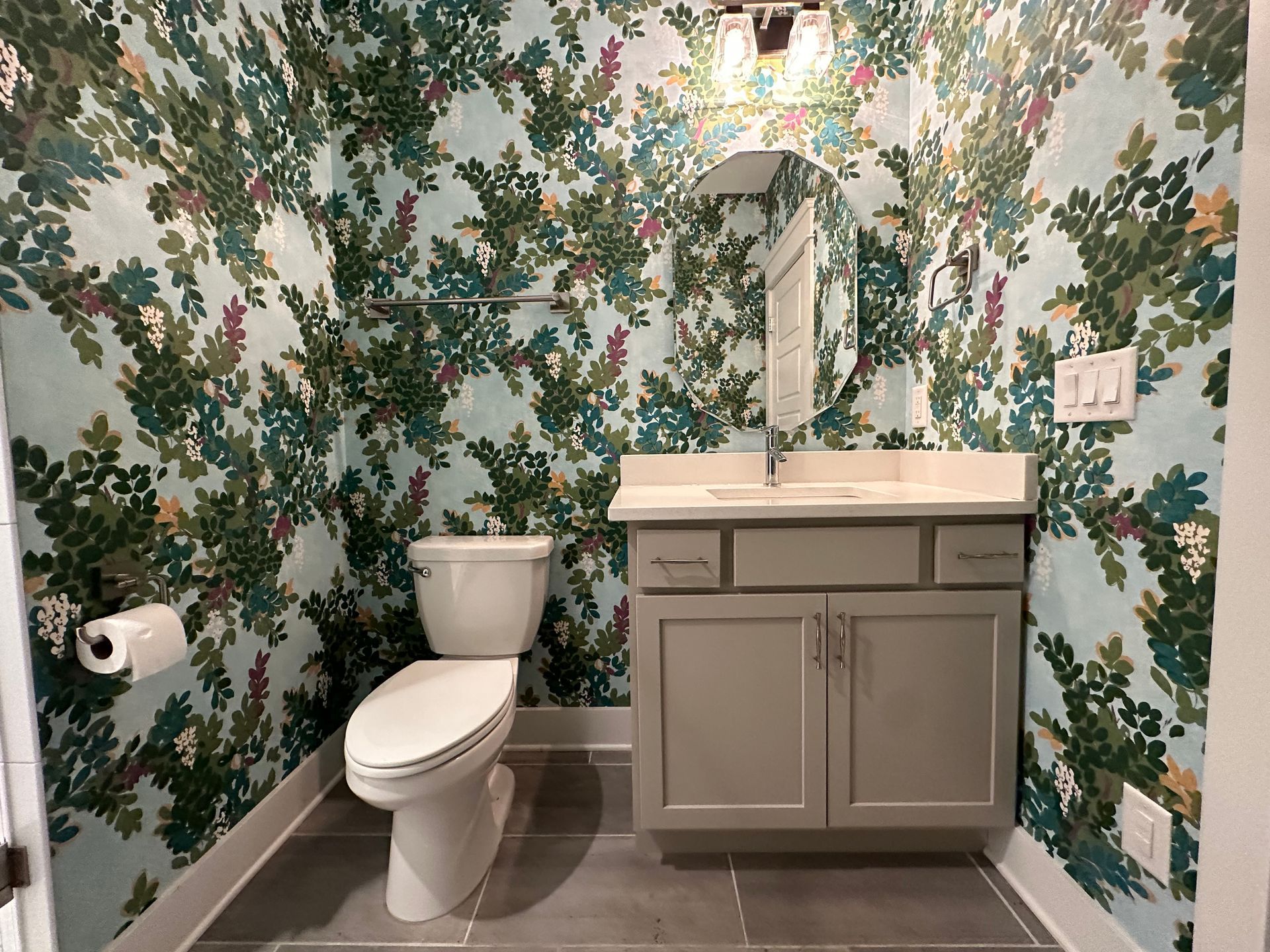 A bathroom with a toilet , sink and mirror