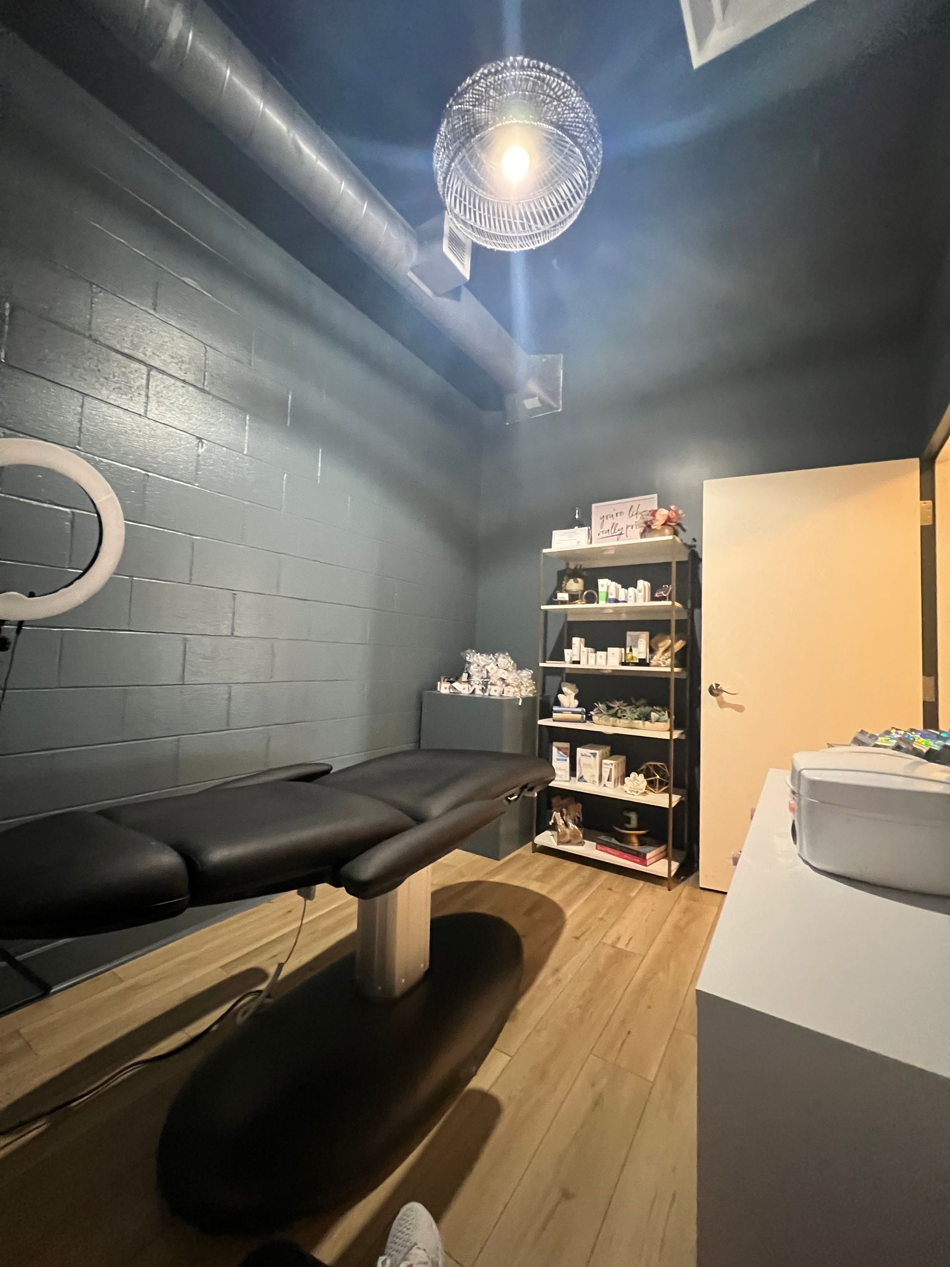 A room with a bed , shelves , and a ceiling light in Nashville, TN