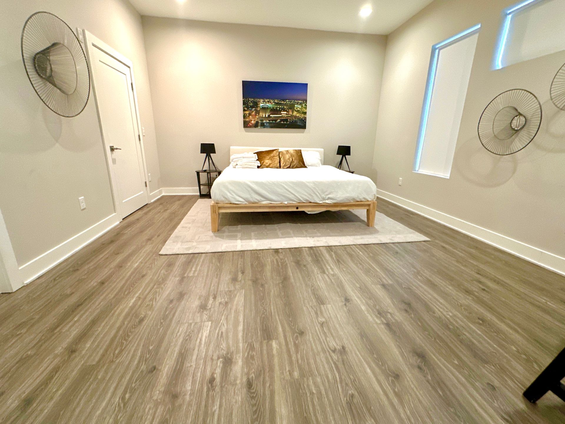 A bedroom with a bed and a painting on the wall