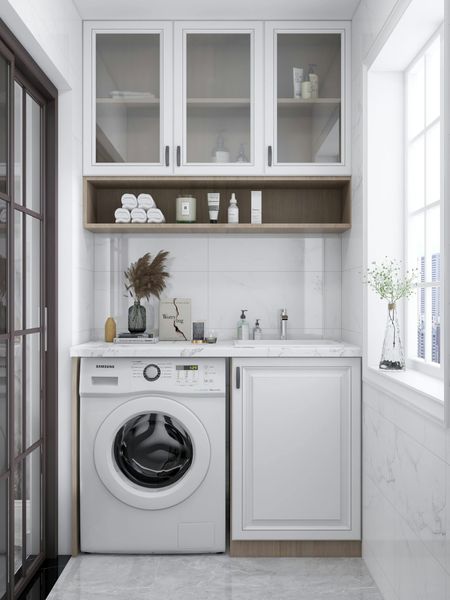A laundry room with a washer and dryer and a sink.