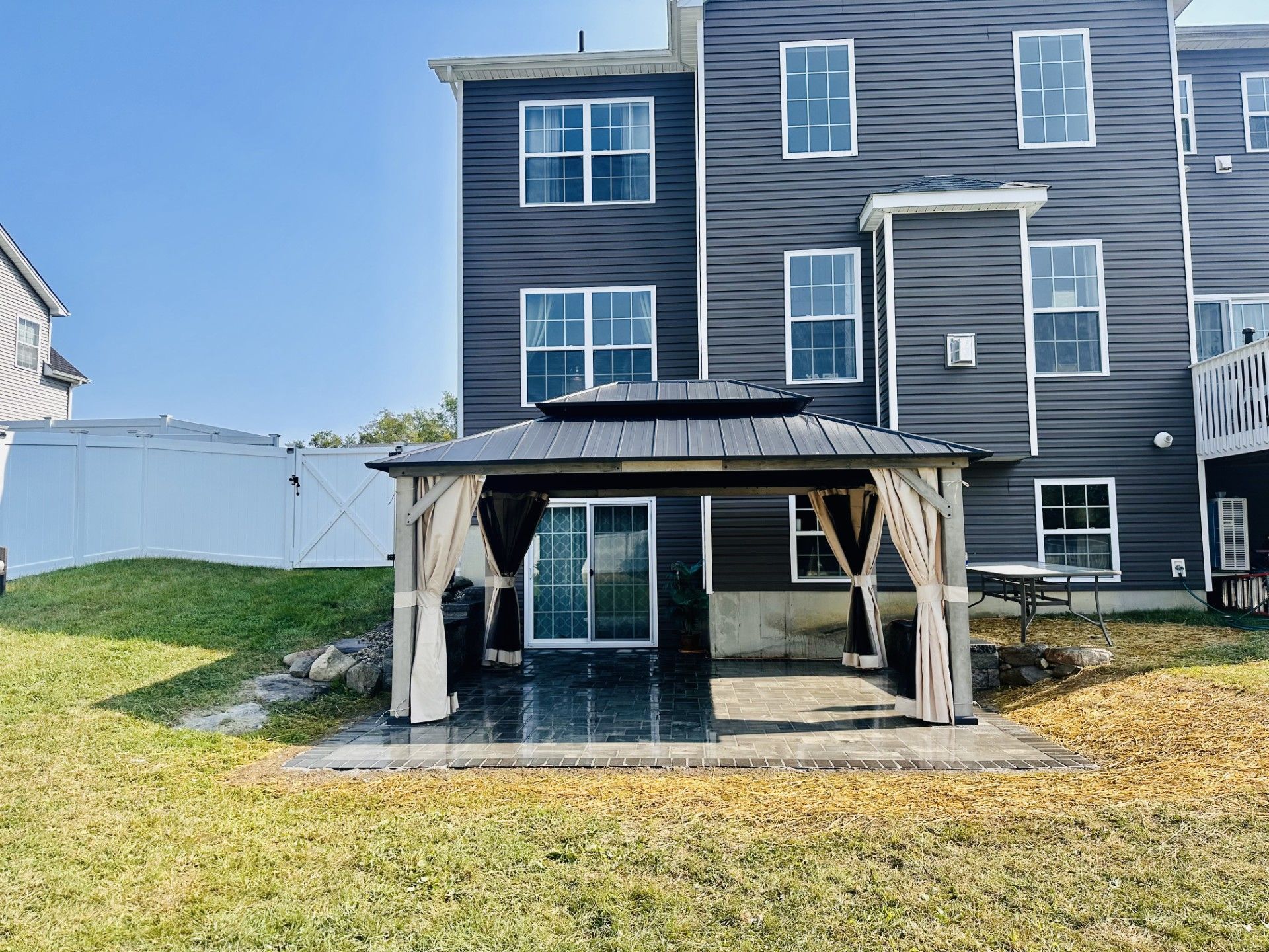 A patio with a table and chairs and an umbrella