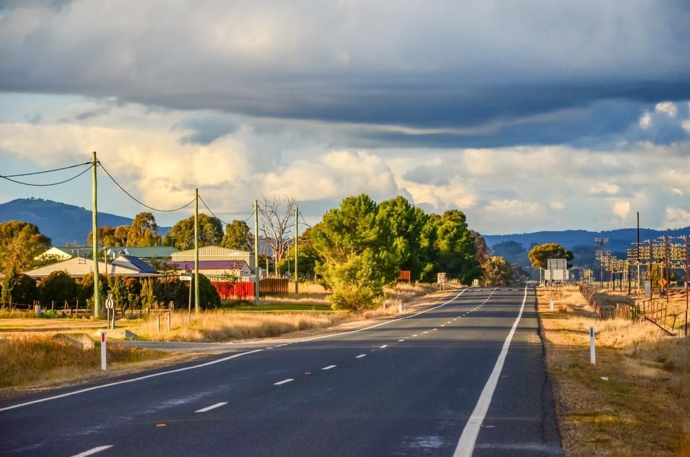 A Road Going Through a Rural Area With a Cloudy Sky in the Background — Solarblu Pty Ltd in Illaroo, NSW