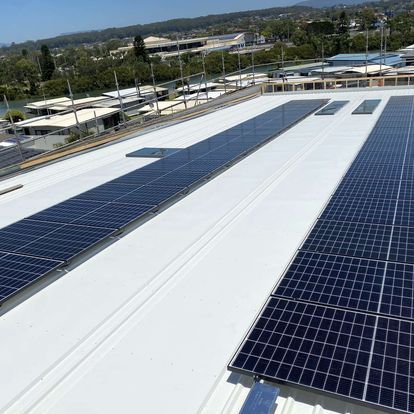 There Are Many Solar Panels On The Roof Of A Building — Solarblu Pty Ltd In Dapto, NSW