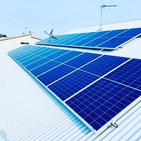 A Row of Blue Solar Panels on a White Roof — Solarblu Pty Ltd in Kangaroo Valley, NSW