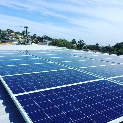 A Row of Solar Panels Are Sitting on Top of a Roof — Solarblu Pty Ltd in Kangaroo Valley, NSW