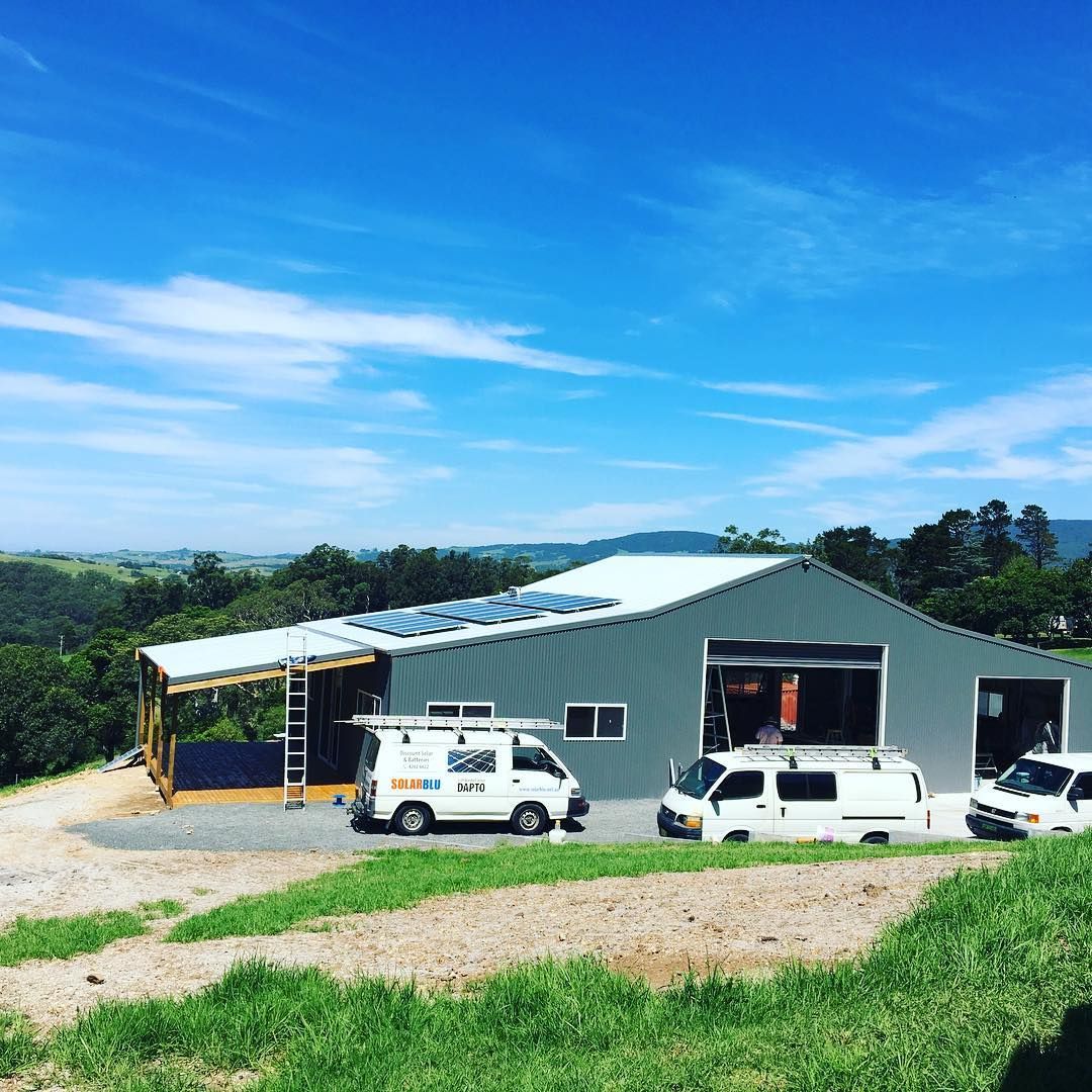 A Roof With Solar Panels On It And A View Of The Ocean — Solarblu Pty Ltd In Dapto, NSW