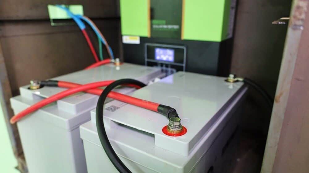 Two Batteries Are Connected To A Charger In A Room — Solarblu Pty Ltd In Kiama, NSW