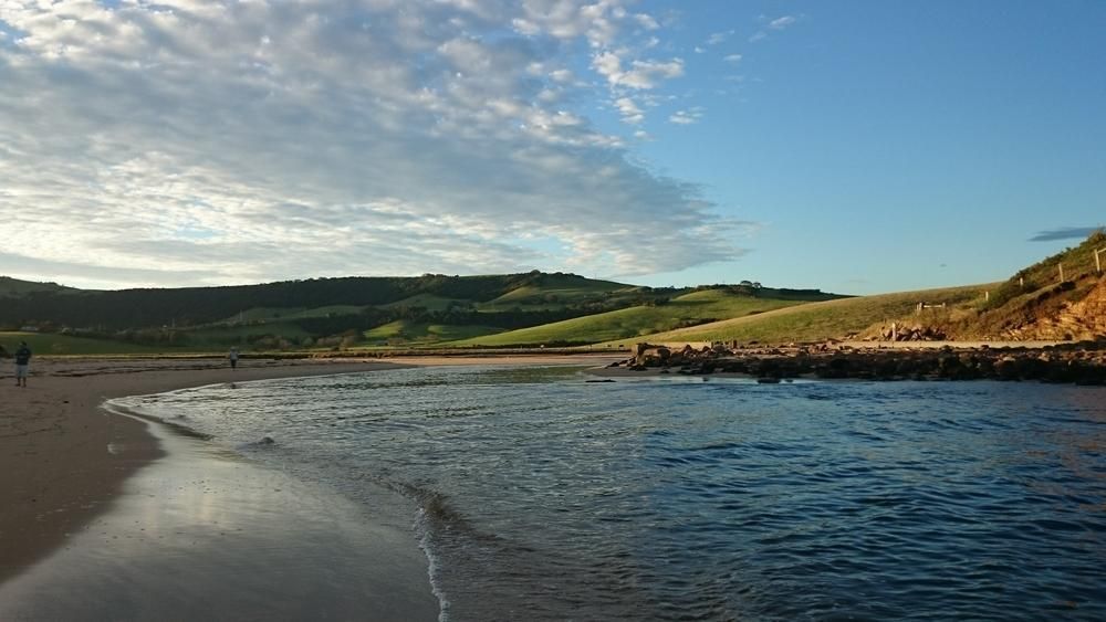 A Beach With a Body of Water and a Mountain in the Background — Solarblu Pty Ltd in Gerringong, NSW