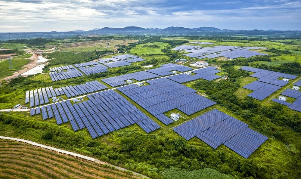 An Aerial View Of A Large Solar Farm In The Middle Of A Lush Green Field — Solarblu Pty Ltd In Bowral, NSW