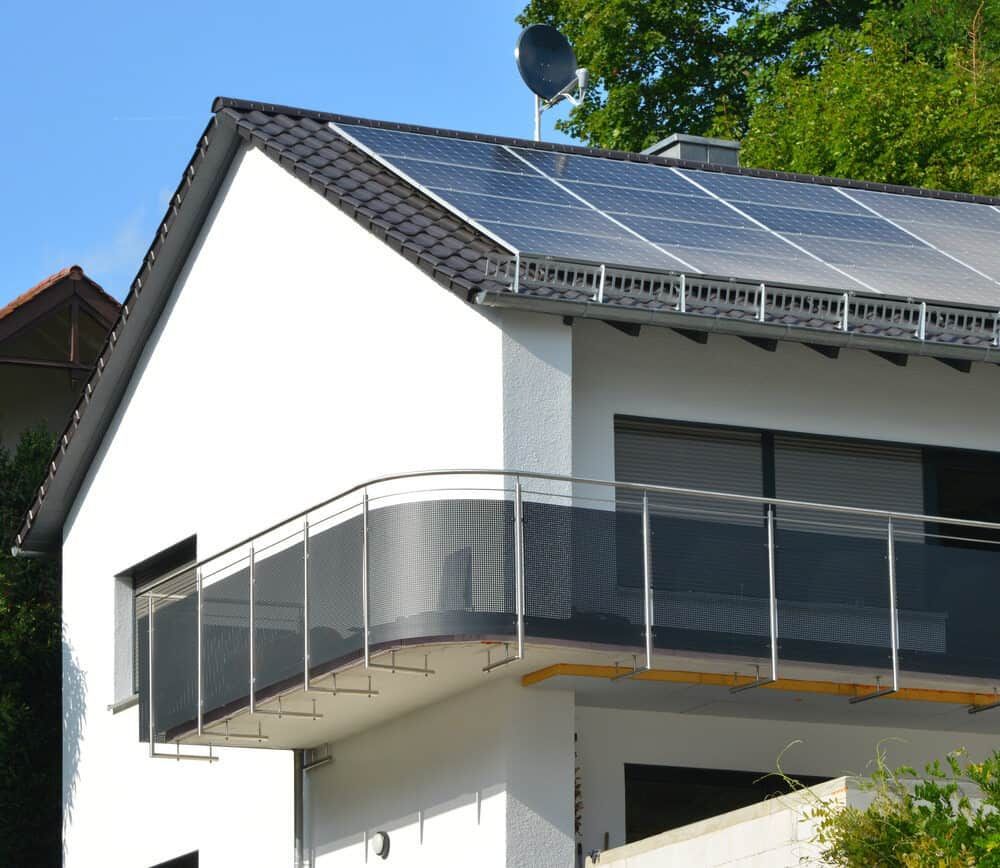 A White House With A Balcony And Solar Panels On The Roof — Solarblu Pty Ltd In Nowra, NSW