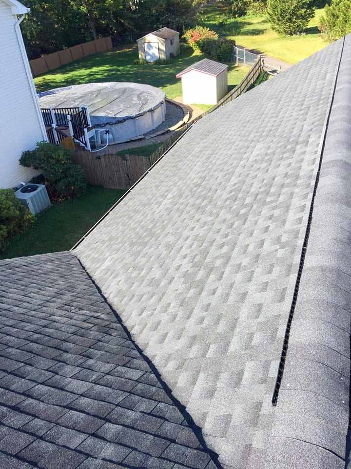 The roof of a house with a pool in the backyard.