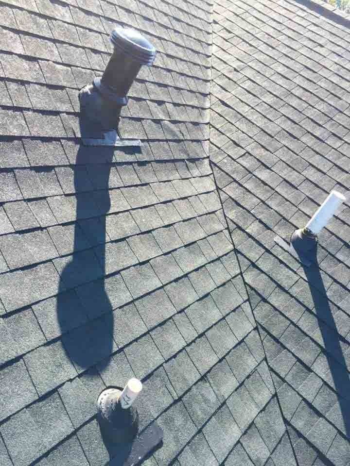 A roof with a chimney and a light on it.