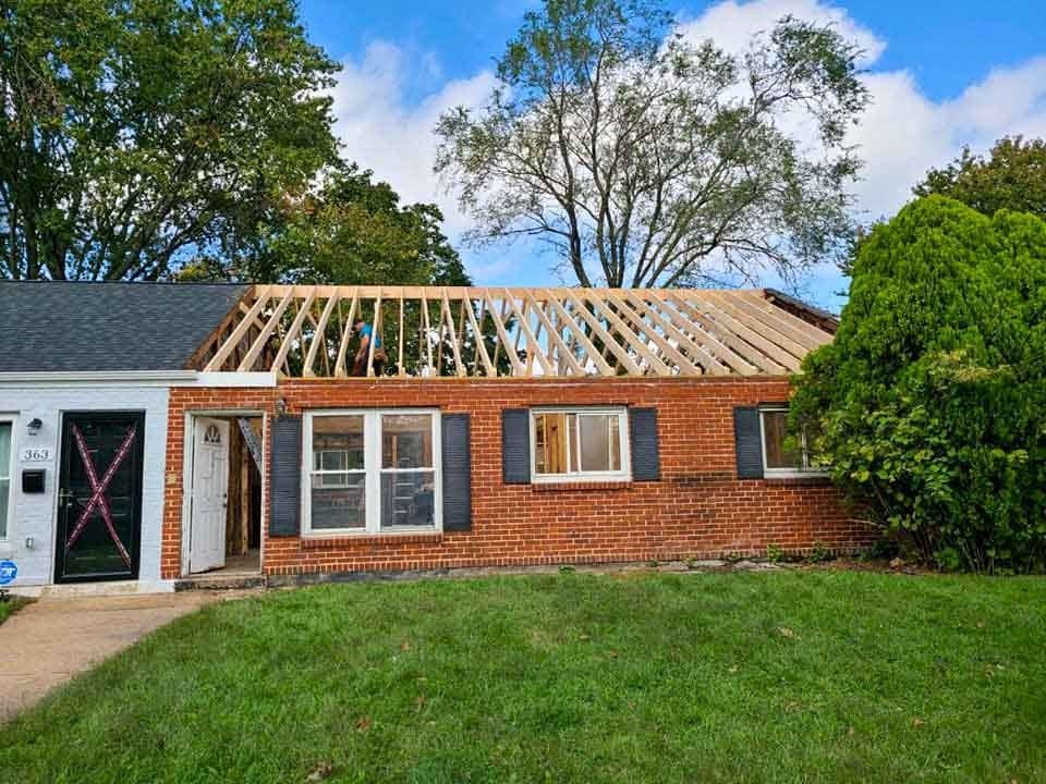 A brick house with a roof that is being built.