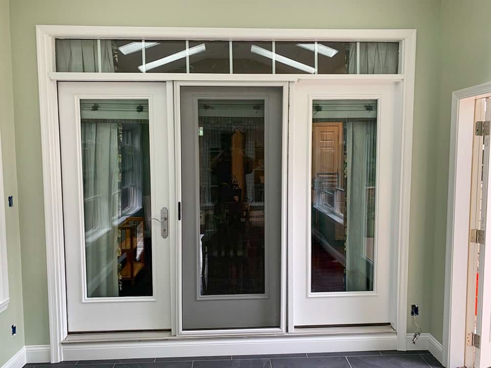 A room with a sliding glass door and a window.