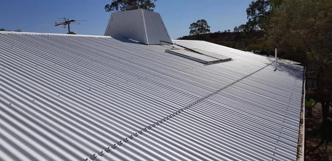 A White Corrugated Metal Roof With a Skylight on Top of It  — NHM Painting & Projects Pty Ltd in Ciccone, NT