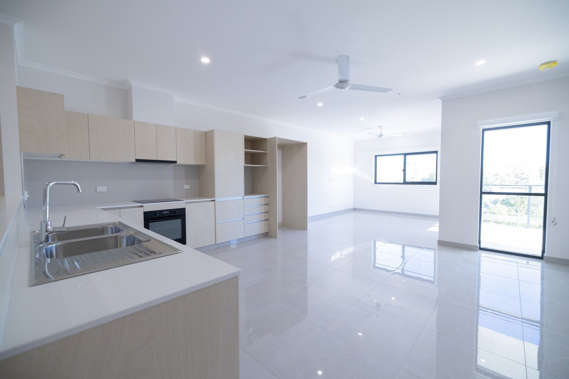 An Empty Kitchen With a Sink and a Ceiling Fan — NHM Painting & Projects Pty Ltd in Ciccone, NT