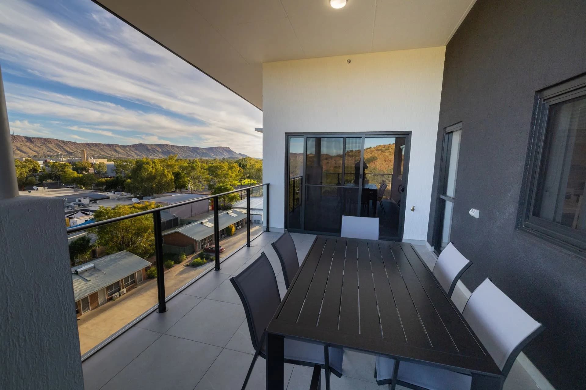 A Balcony With a Table and Chairs and a View of a City — NHM Painting & Projects Pty Ltd in Ciccone, NT