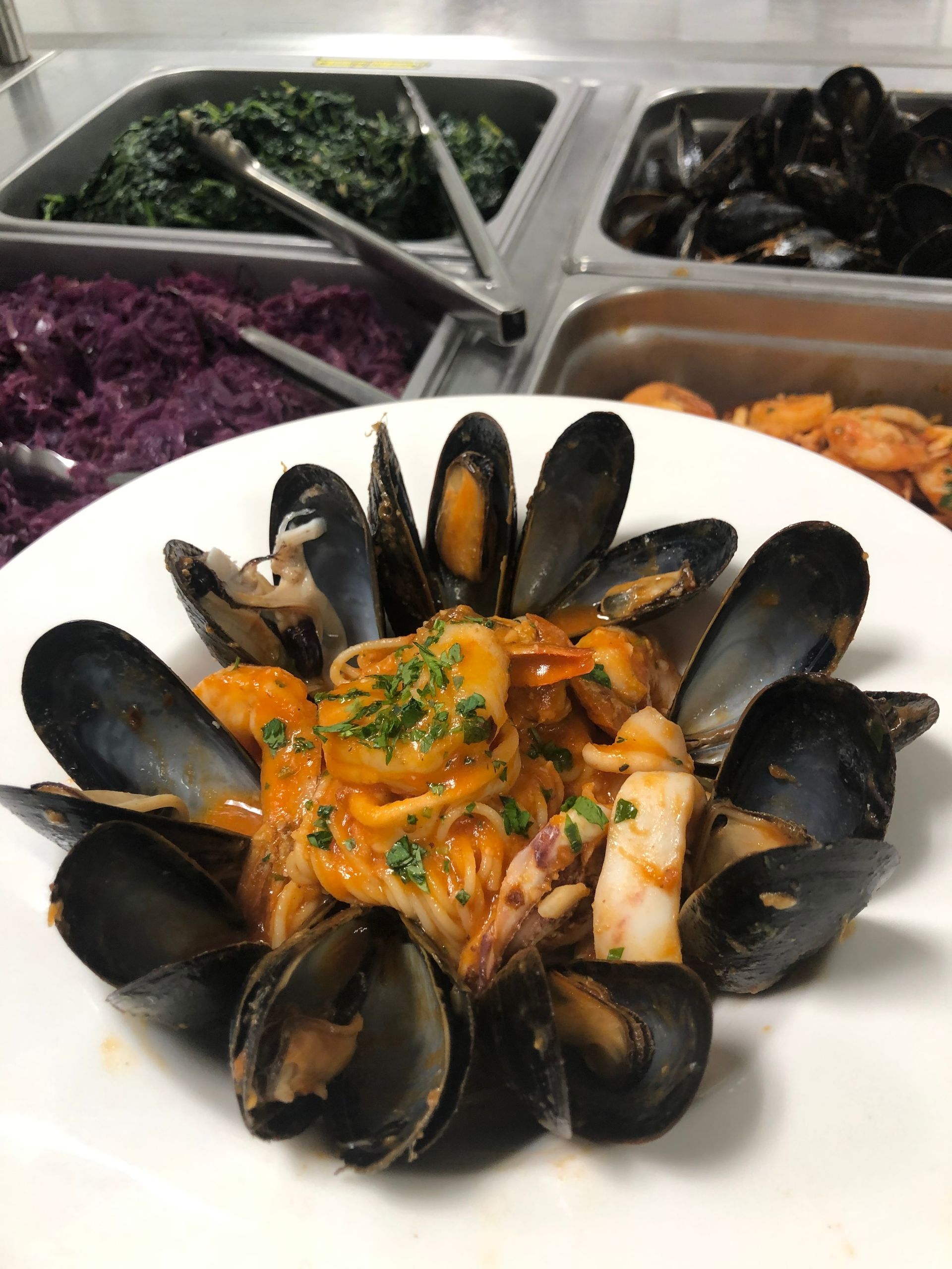 Plate of seafood pasta with mussels, squid, and shrimp.