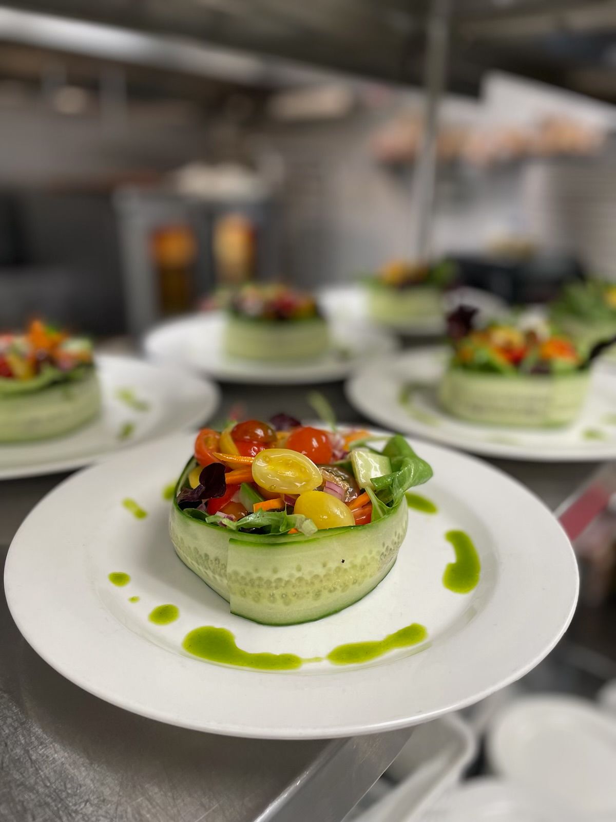 Buffet table with stainless steel chafing dishes, white plates, and utensils.