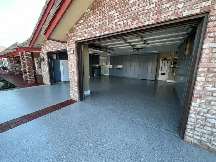Seamless gray epoxy coating in a residential two-car garage.