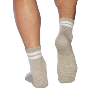 A pair of black socks with white stripes on the bottom