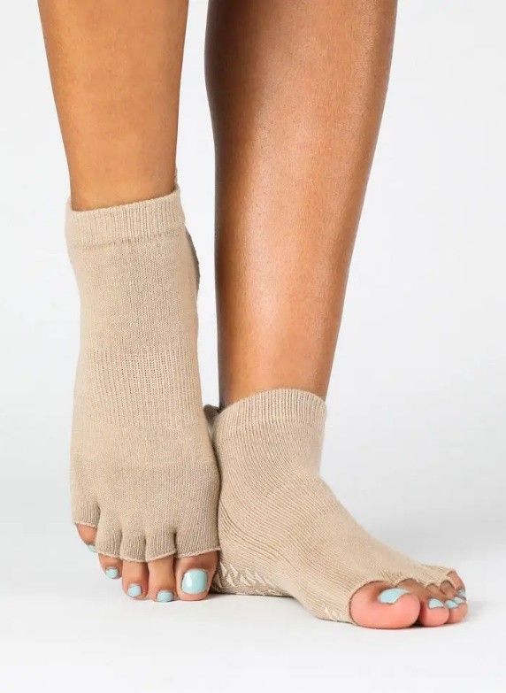 A woman is wearing a pair of toeless socks.