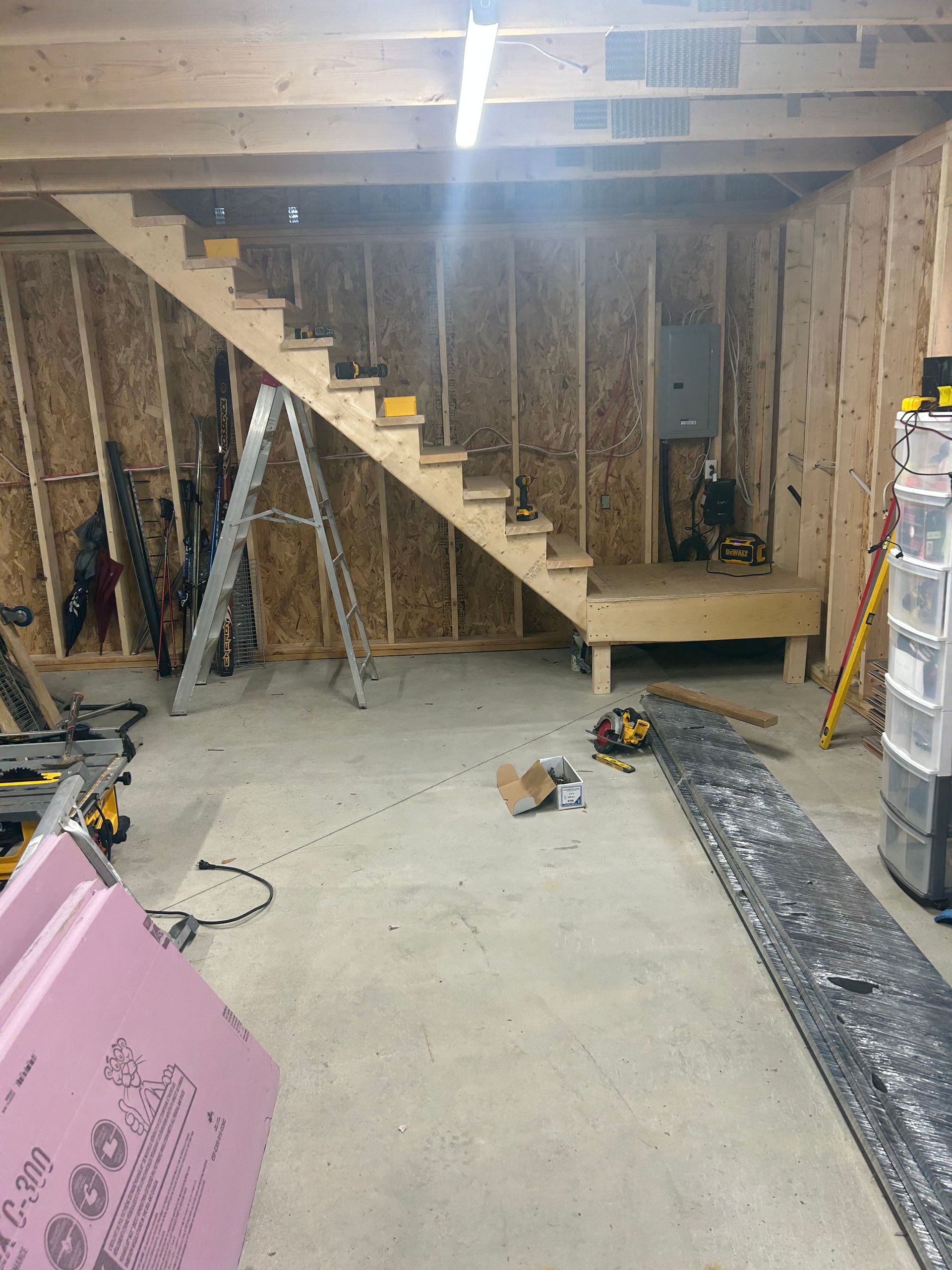 Un escalier en bois est en cours de construction dans un garage.
