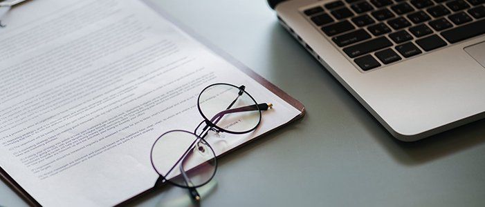 eyeglass, papers, laptop