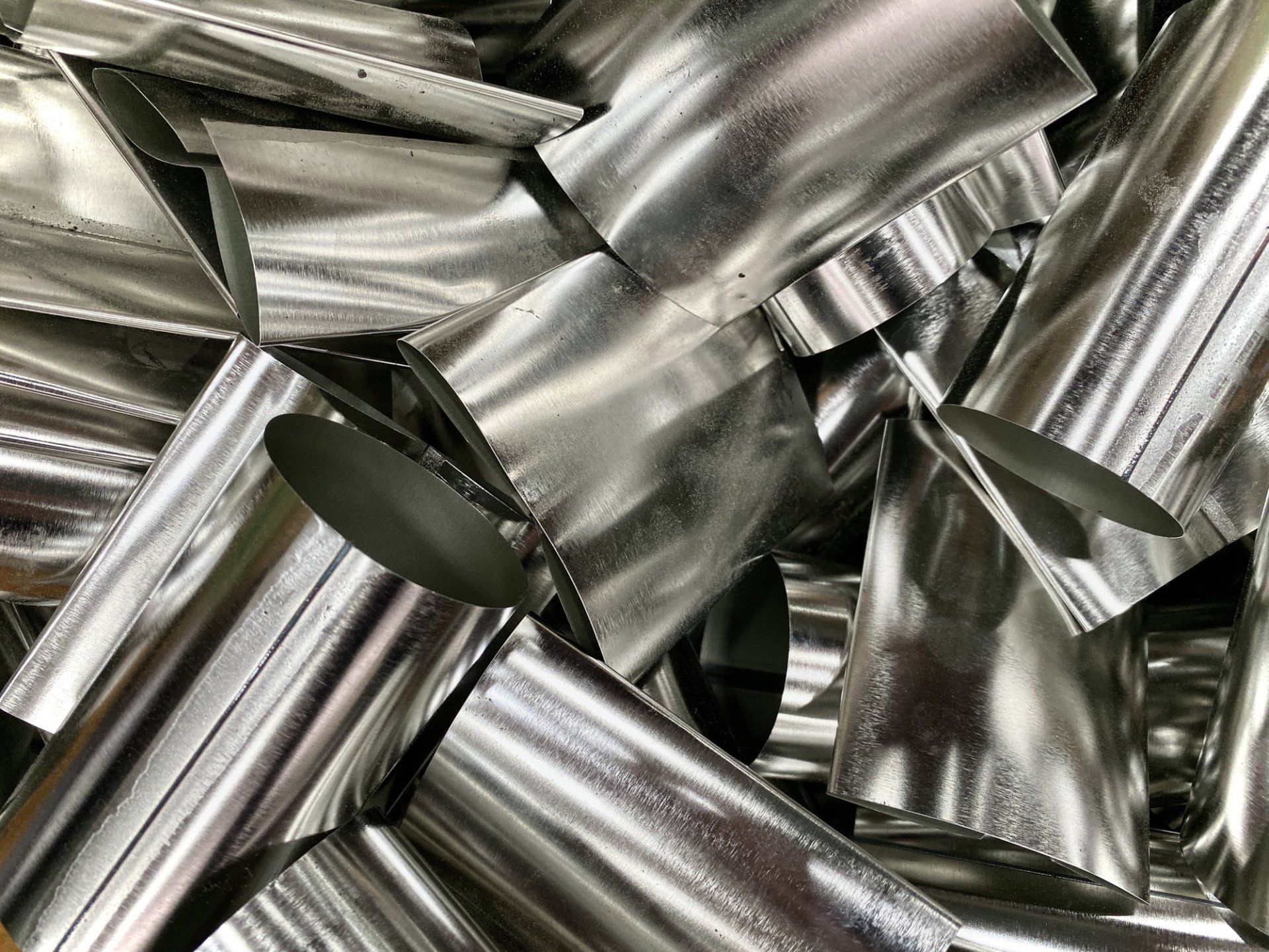 A pile of aluminum cans sitting on top of each other on a table.