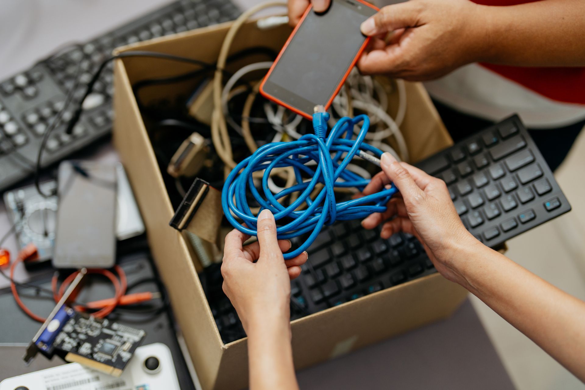 ITAD electronic waste recycling process showing workers handling e-waste responsibly.