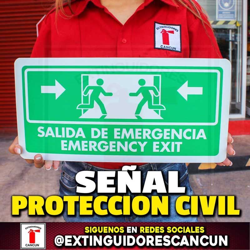 A person holding a sign that says salida de emergencia emergency exit
