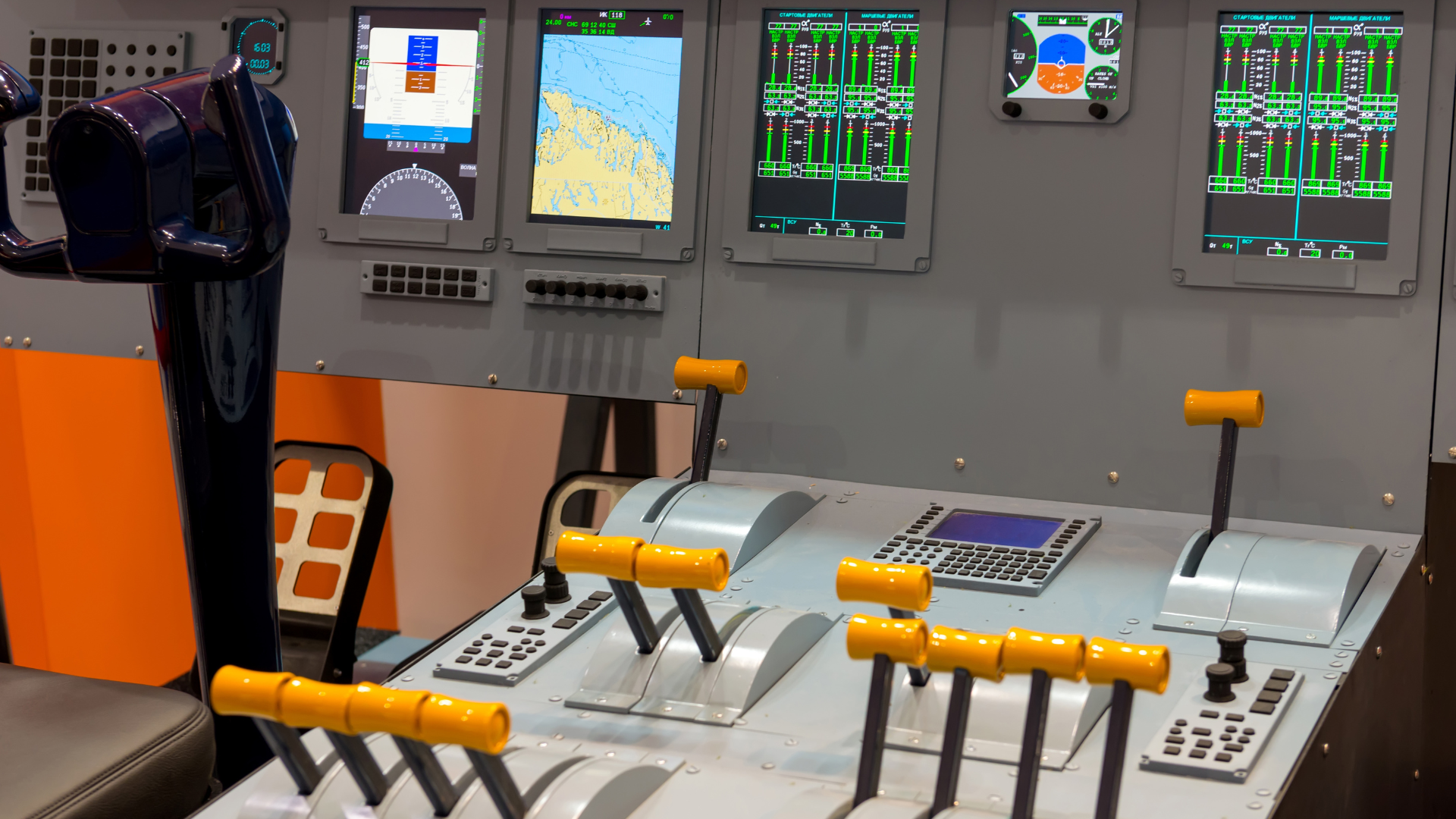 Aircraft cockpit interior with screens displaying flight data and control levers.