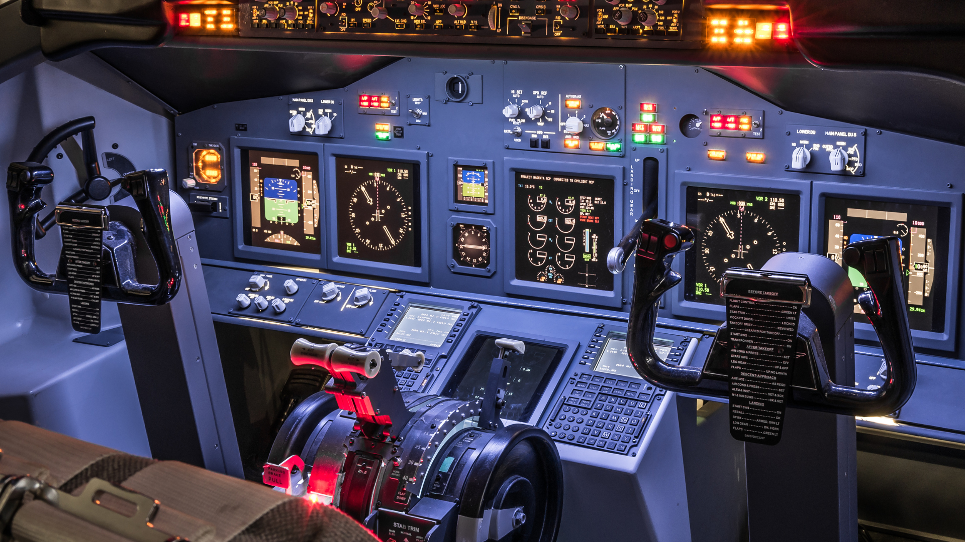 Cockpit of a commercial airliner, illuminated dials and screens. Control yokes and throttles are visible.
